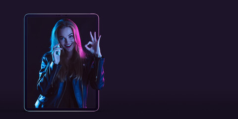 Beautiful woman inviting for shopping right from device screen, black friday, sales concept. Flyer. Cyber monday and online purchases, negative space for ad. Finance and money. Dark neon background.