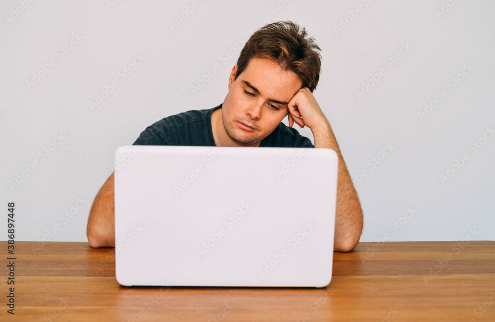 Young Redhead Guy Tired, Bored and Fed Up of Study with his Laptop Young Redhead Guy Tired, Bored and Fed Up of Study with his Laptop