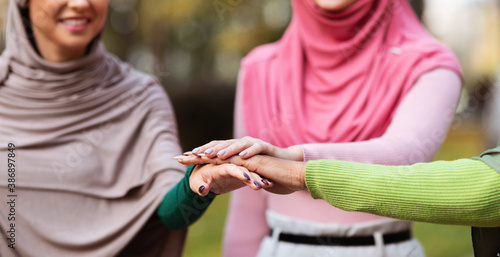 United Muslim Women In Hijab Holding Hands Standing Outdoors, Cropped