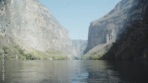 Navigating on a boat across the Grijalba River between the high mountains of the Sumidero Canyon in Mexico