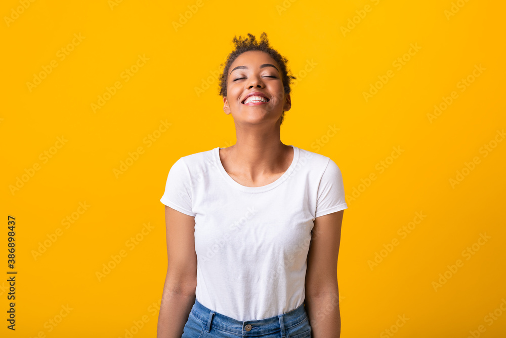 Portrait of laughing afro woman with closed eyes Portrait of laughing afro woman with closed eyes