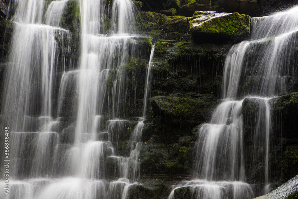 Hidden cascading waterfall in a deep gorge with trickling white water. Forest of Bowland, Ribble Valley, Lancashire Hidden cascading waterfall in a deep gorge with trickling white water. Forest of Bowland, Ribble Valley, Lancashire