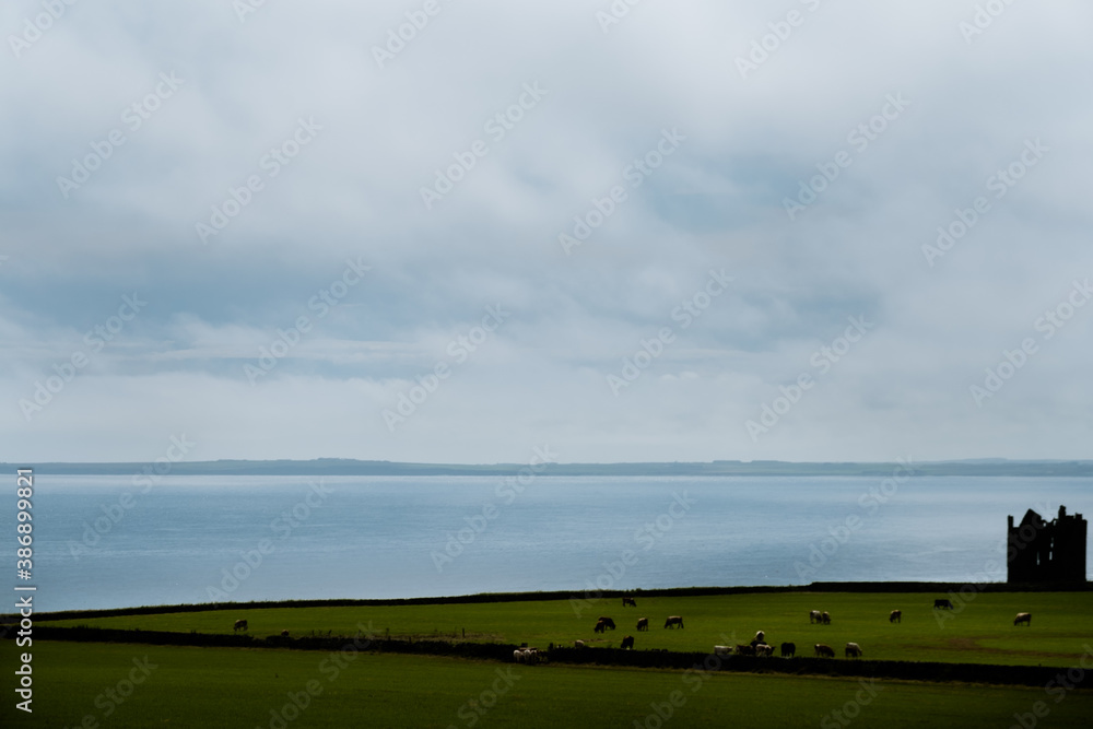 silhouette of castle with sea in background, East Coast, Scotland silhouette of castle with sea in background, East Coast, Scotland