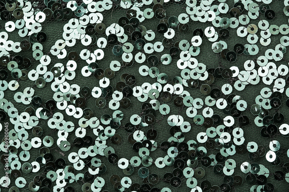 Close up photo of circle green sequins on fabric Close up photo of circle green sequins on fabric