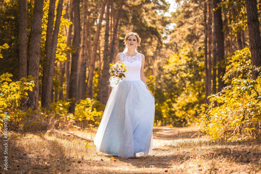happy bride with a bouquet is walking the green park happy bride with a bouquet is walking the green park