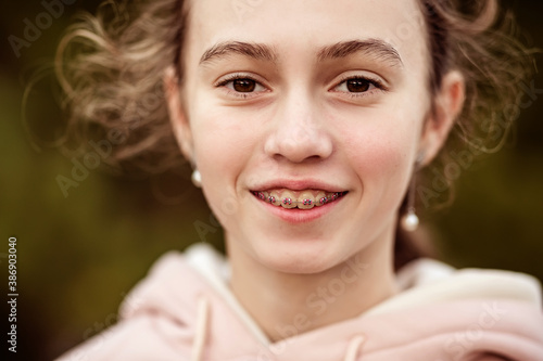 Close-up portrait of a teenage girl in braces.