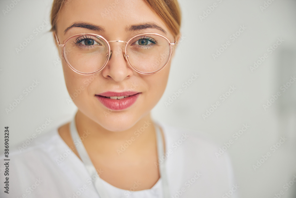 Smiling calm cosmetician posing for the camera Smiling calm cosmetician posing for the camera
