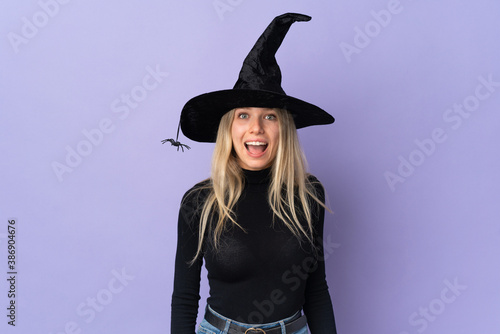 Young woman with witch costume over isolated background with surprise facial expression