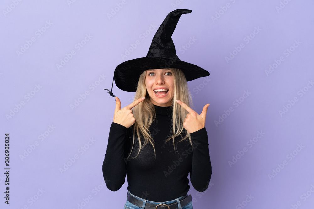 Young woman with witch costume over isolated background giving a thumbs up gesture Young woman with witch costume over isolated background giving a thumbs up gesture