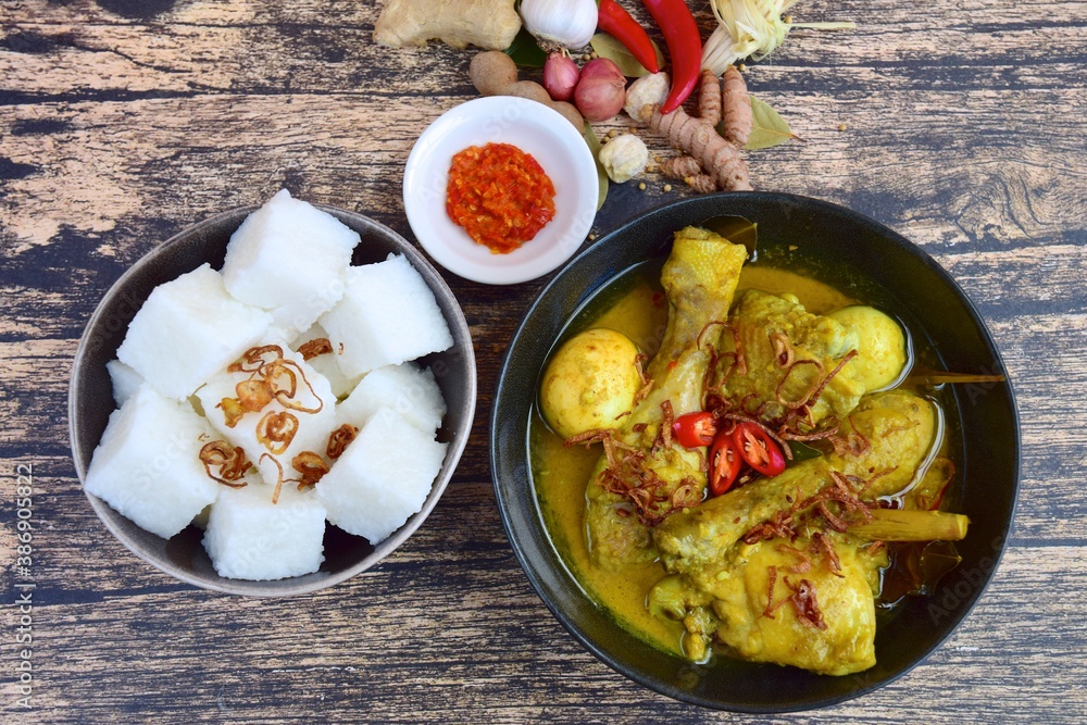 Opor ayam, chicken cooked in coconut milk from Indonesia, from Central Java, added with boiled eggs, served with lontong and sambal. Popular dish for lebaran or Eid al-Fitr