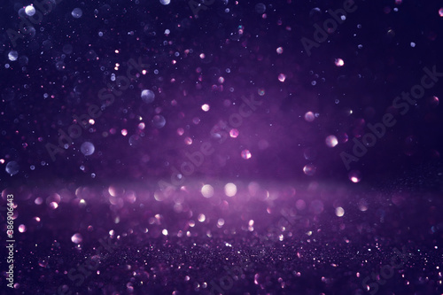 background of abstract glitter lights. black and purple. de focused © tomertu
