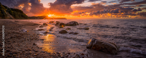 Colorful sunset over the sea and rocky shore