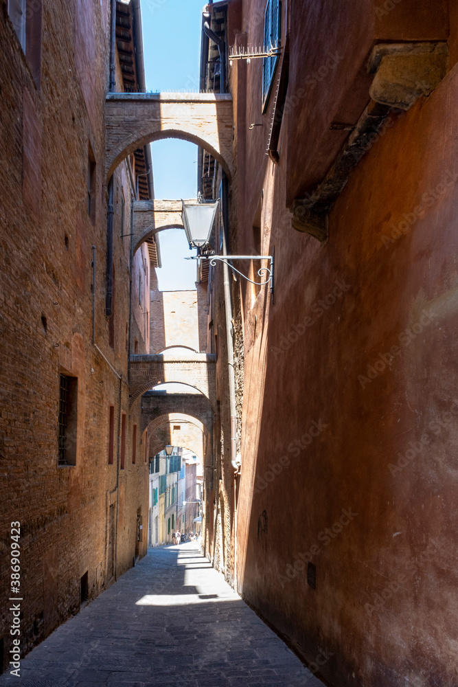 old narrow alley in tuscan village. antique italian lane in Siena, Tuscany, Italy
