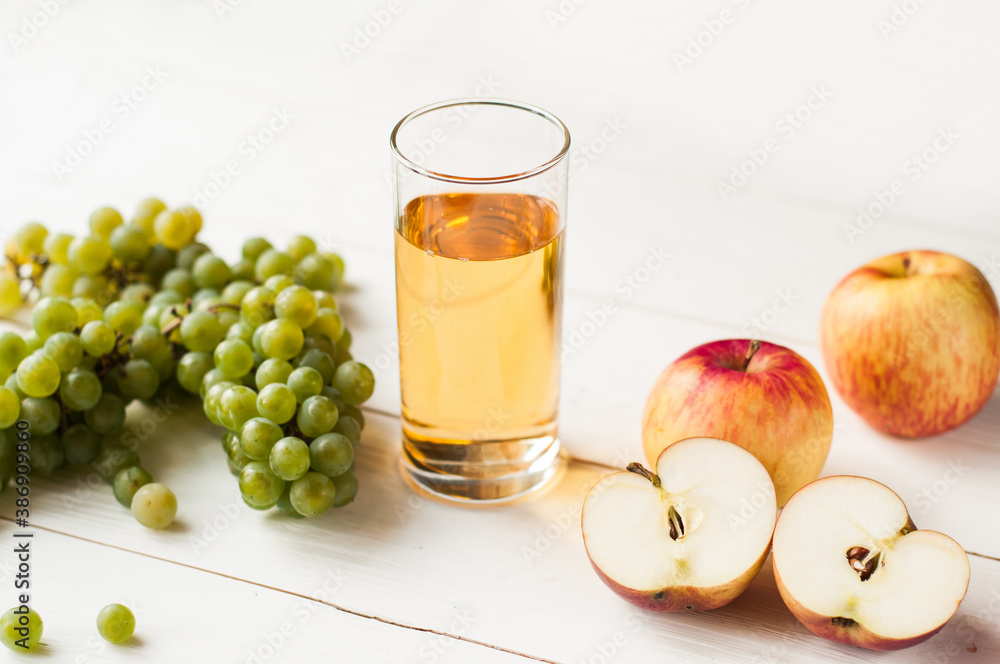 fresh grape fruits with green leaves isolated on white background. bunch of green grapes and juice in the glass, pitcher. fresh grape fruits with green leaves isolated on white background. bunch of green grapes and juice in the glass, pitcher.