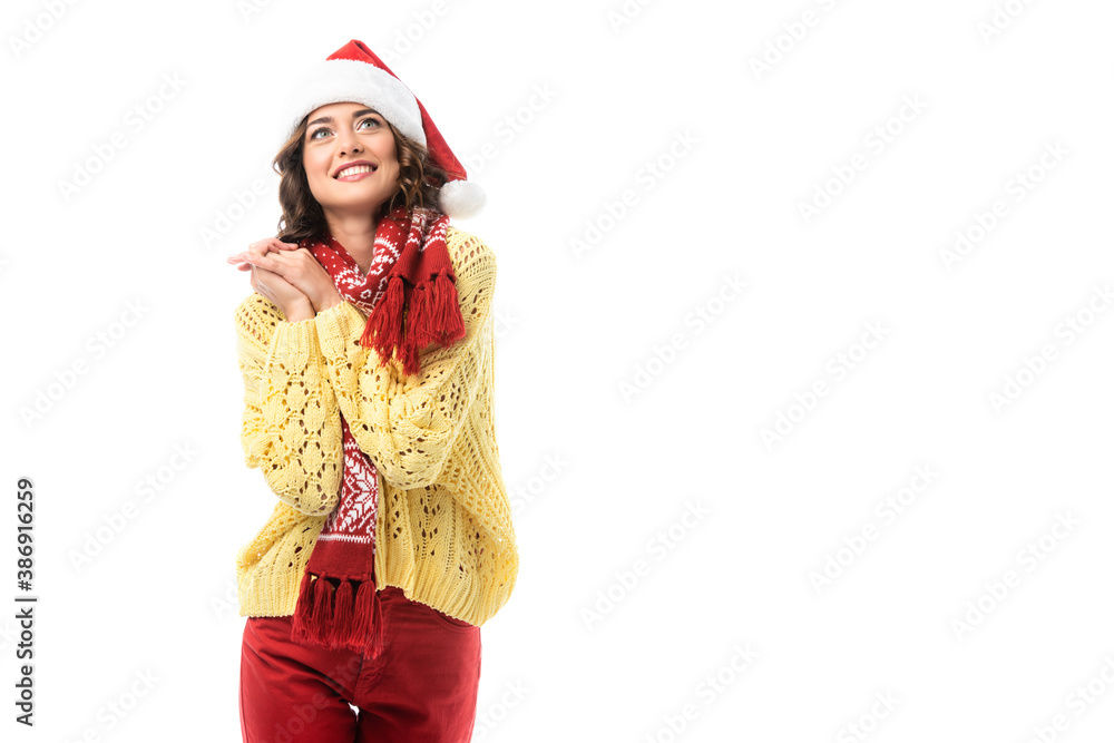 young dreamy woman in santa hat and red scarf smiling isolated on white young dreamy woman in santa hat and red scarf smiling isolated on white