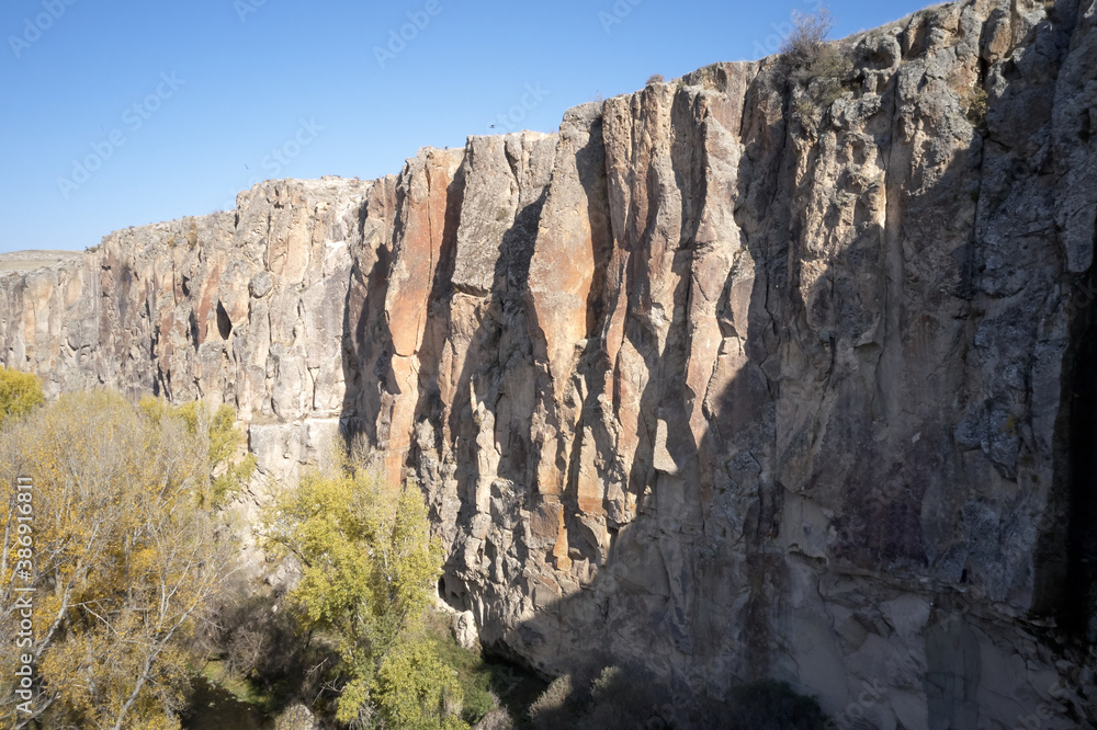 Ihlara valley and the gorge. Blue clear sky in the background. Beautiful rock formations. Cappadocia, Turkey, Aksaray province.