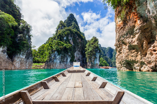 Traditional longtail boat with beautiful scenery view in Ratchaprapha Dam at Khao Sok National Park, Surat Thani Province, Thailand. © Southtownboy Studio