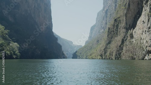Navigating on a boat across the Grijalba River between the high mountains of the Sumidero Canyon in Mexico