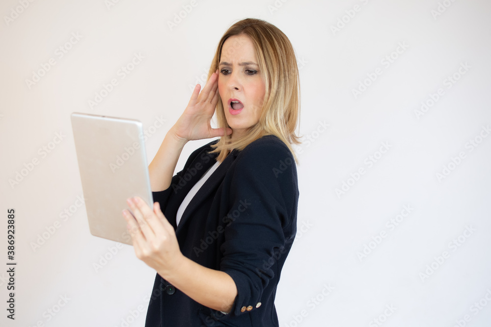 Surprised businesswoman holding a tablet in her hands Surprised businesswoman holding a tablet in her hands