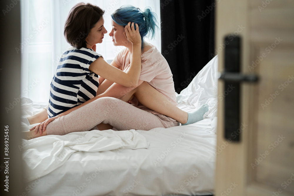 Lesbian couple together in the bedroom Lesbian couple together in the bedroom