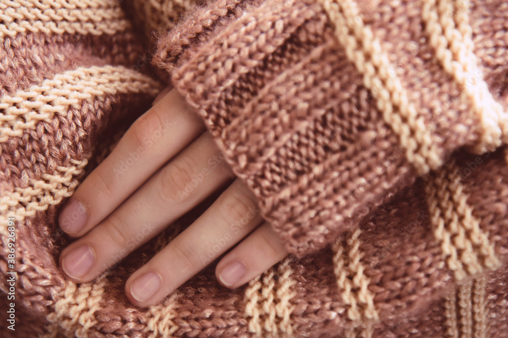 Woman in a beige soft warm knitted sweater folded her arms. Autumn soon Woman in a beige soft warm knitted sweater folded her arms. Autumn soon