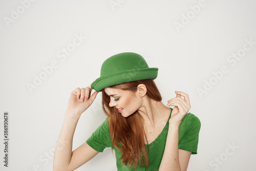happy woman in green clothes in st patricks day shamrock hat makeup model