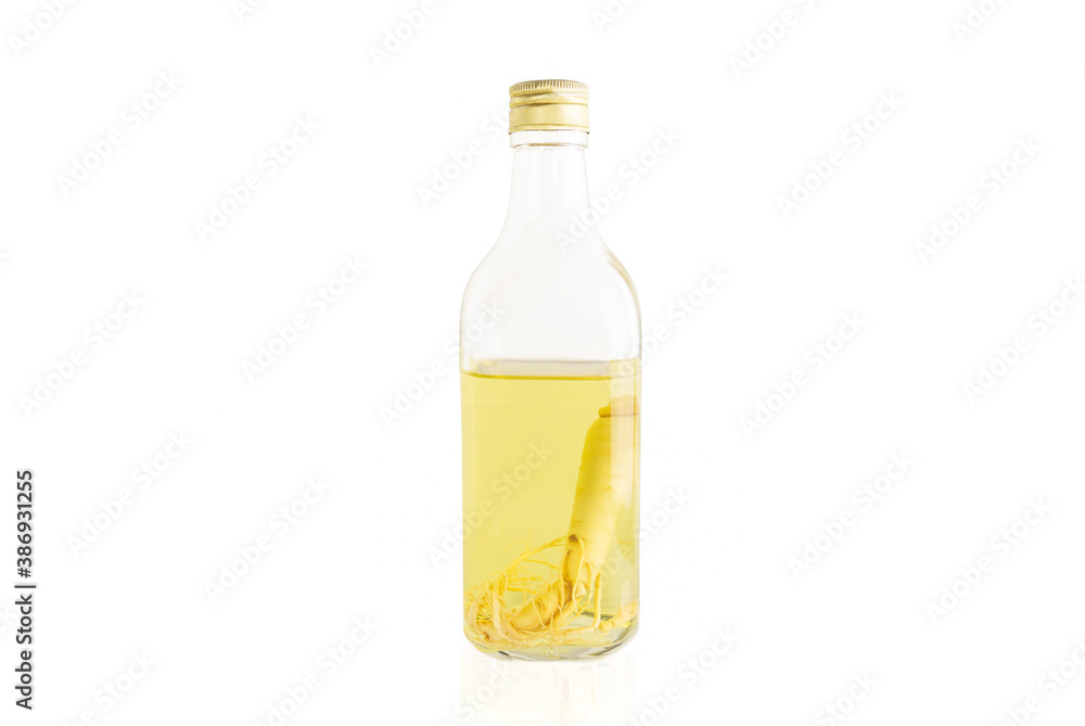 Ginseng roots in the glass bottle isolated in white background. Ginseng roots in the glass bottle isolated in white background.