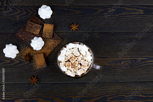 Cup of hot chocolate with marshmallows and cinnamon. Ingredients for making cocoa drink . Top view, copy space.