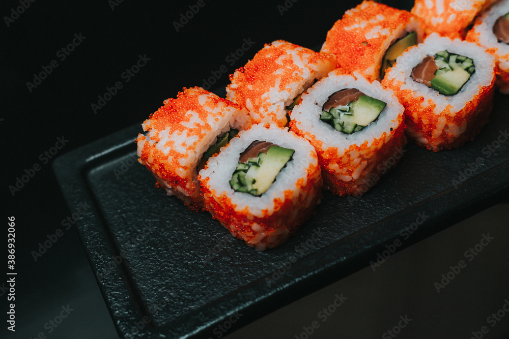 sushi on a black plate sushi on a black plate