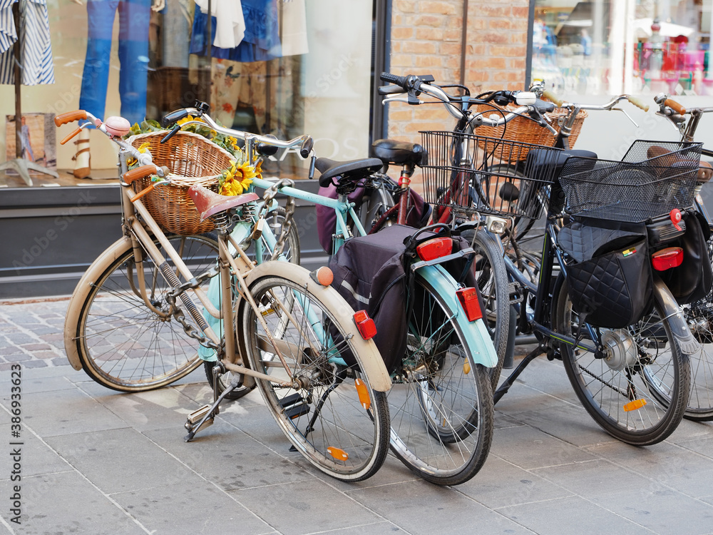 Ferrara, Italy. Bicycles parked in front of a shop.