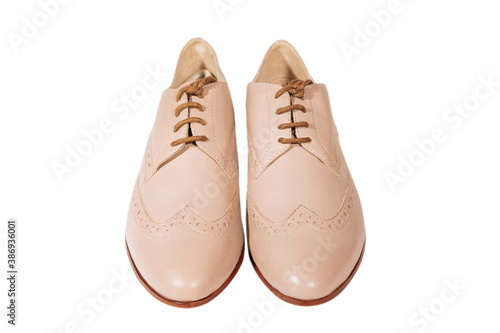 Woman beige leather shoes with low heel isolated on the white background. Front view