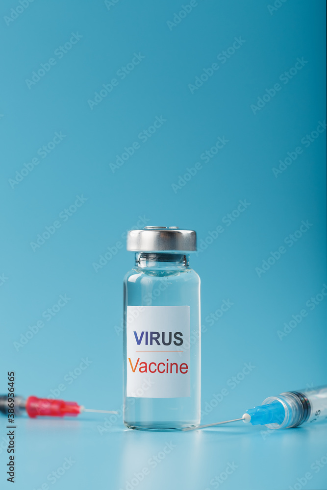 Syringes and ampoule with the vaccine against the Virus from diseases on a blue background. Syringes and ampoule with the vaccine against the Virus from diseases on a blue background.