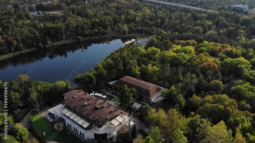 Aerial view with drone over a city, House located in the middle of the park. Beautifully protected lake. Flying birds. The city of Chisinau seen from above. Beautiful landscape Aerial view with drone over a city, House located in the middle of the park. Beautifully protected lake. Flying birds. The city of Chisinau seen from above. Beautiful landscape