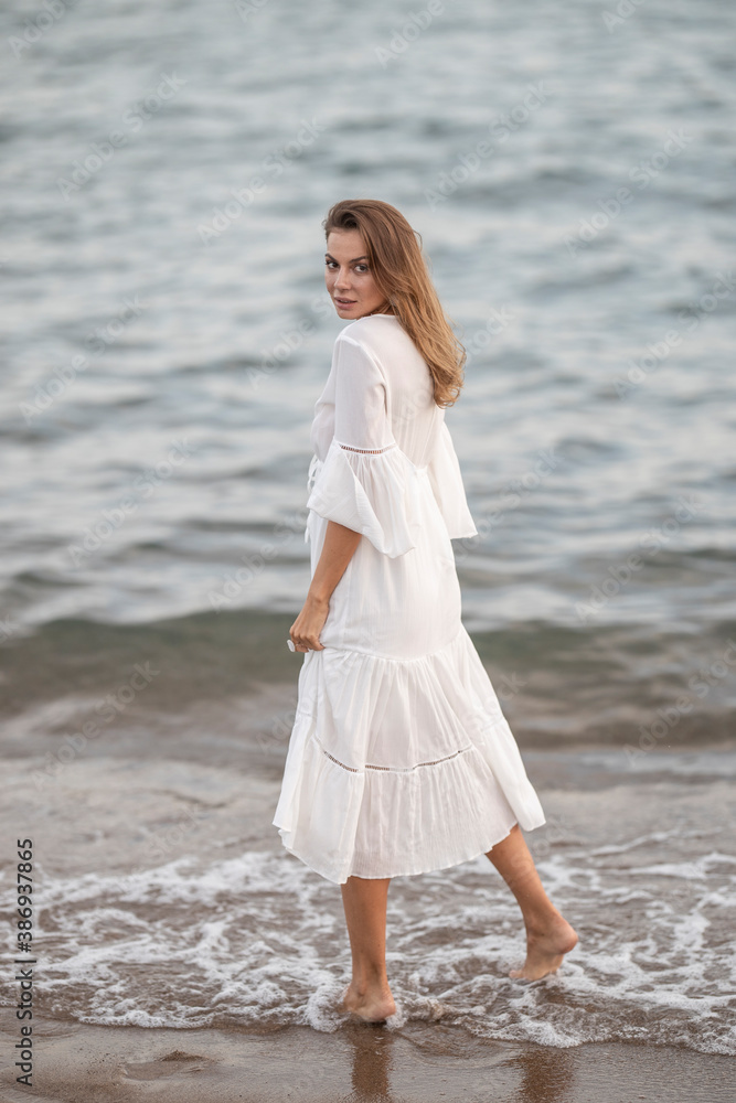 beautiful woman in white dress by the sea beautiful woman in white dress by the sea