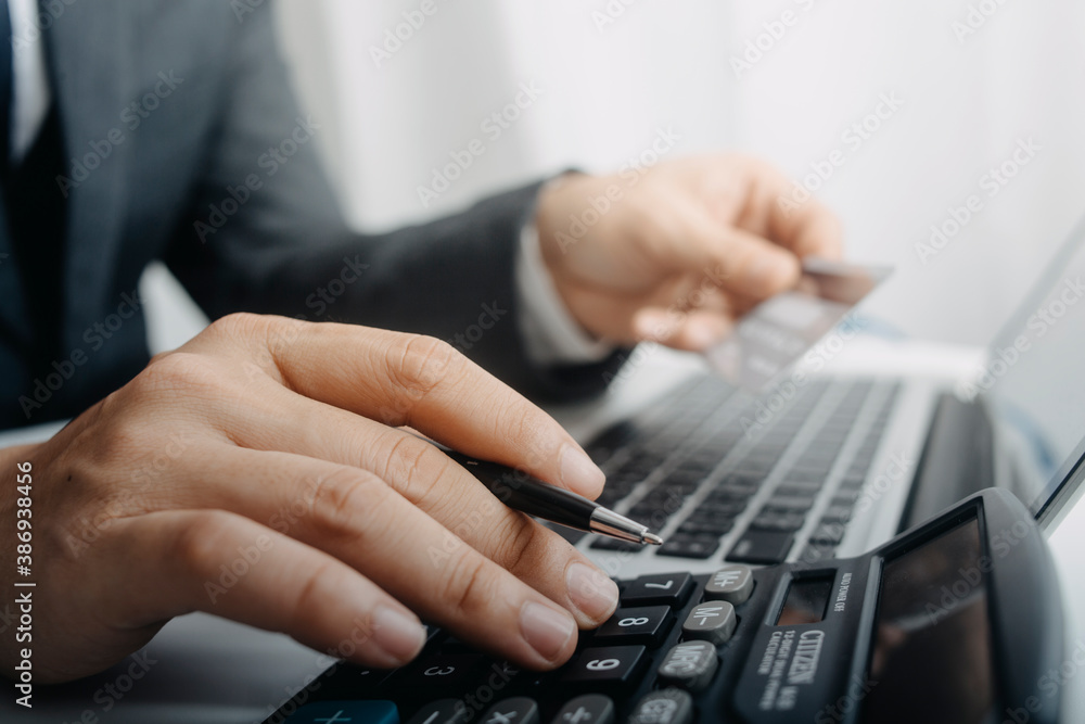 businesswoman hand using smart phone, tablet payments and holding credit card online shopping, omni channel, digital tablet docking keyboard computer at office in sun light businesswoman hand using smart phone, tablet payments and holding credit card online shopping, omni channel, digital tablet docking keyboard computer at office in sun light
