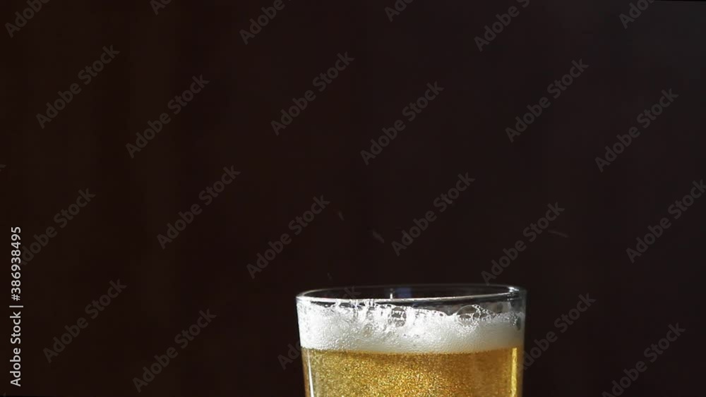 Macro Shot Of Pouring Light Beer Into Glass. Foam of beer Macro Shot Of Pouring Light Beer Into Glass. Foam of beer