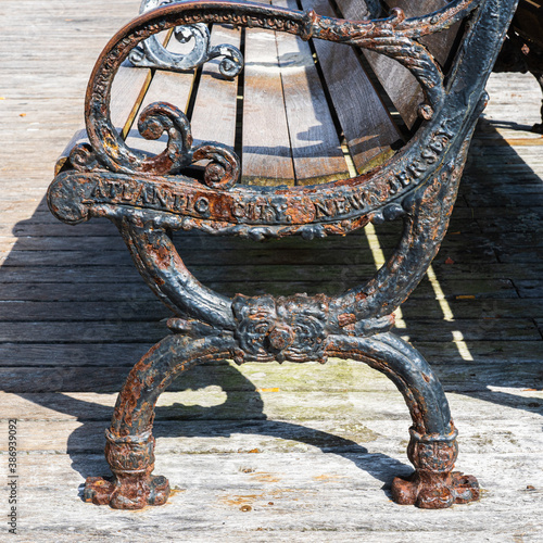 rusted and weathered cast iron bench on the Atlantic City New Jersey boardwalk