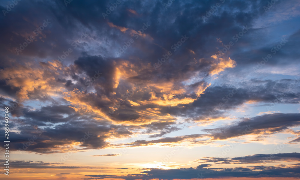 Sunset sky with clouds in blue and orange colors. Sunset sky with clouds in blue and orange colors.