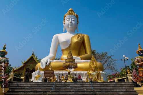 Enormous Buddha statue in Wat Phra Tat Doi Kham temple in Chiang Mai, Thailand, Asia © Monique