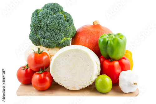 Group vegetables and Fruits Apples, grapes, oranges, and bananas in the wooden basket with carrots, tomatoes, guava, chili, eggplant, and salad on the white background