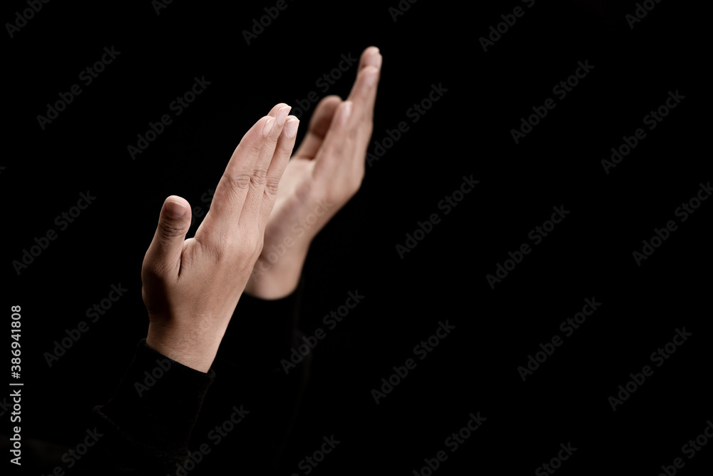 Woman's hand praying and worship to GOD Using hands to pray in religious beliefs and worship christian in the church or in general locations in vintage color tone or copy space. Woman's hand praying and worship to GOD Using hands to pray in religious beliefs and worship christian in the church or in general locations in vintage color tone or copy space.