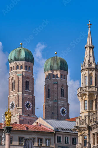 The towers of Frauenkirche church (Cathedral of Our Dear Lady) and detail of the Neues Rathaus (New Town Hall) in Munich, Germany