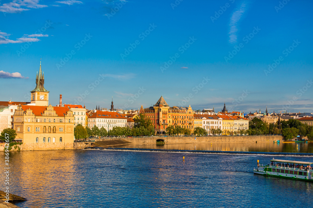 Summer landscape of Prague view of the Ltava river on which ferries with tourists float