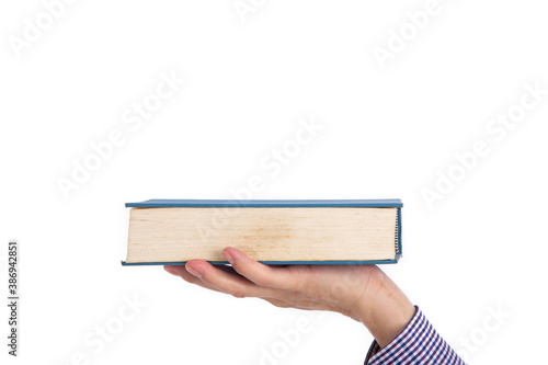 Male hand holding a book isolated on a white