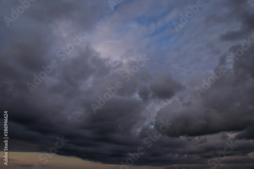 Epic Dramatic Storm sky, dark grey violet clouds against blue sky background texture, thunderstorm