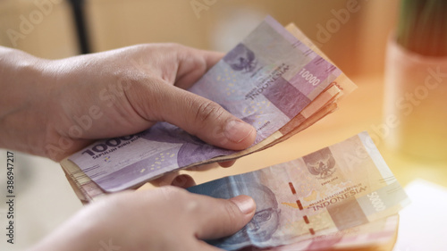 Close up of a person counting money, Uang Indonesian rupiah