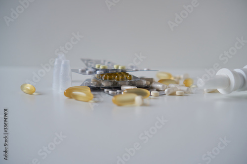 Assorted pharmaceutical medicine pills, tablets and capsules, nasal spray                         