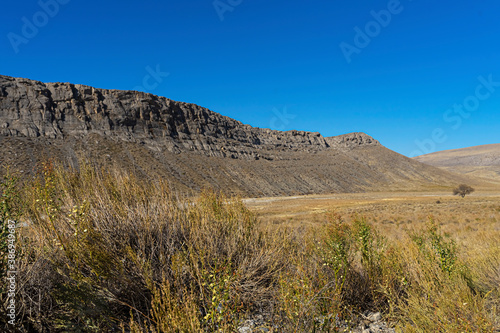 Mountains in the fall. Karatau mountains in southern Kazakhstan. Mountain plants in autumn. Rocks. Mountain stones. Rocks. Dry grass. Blue sky