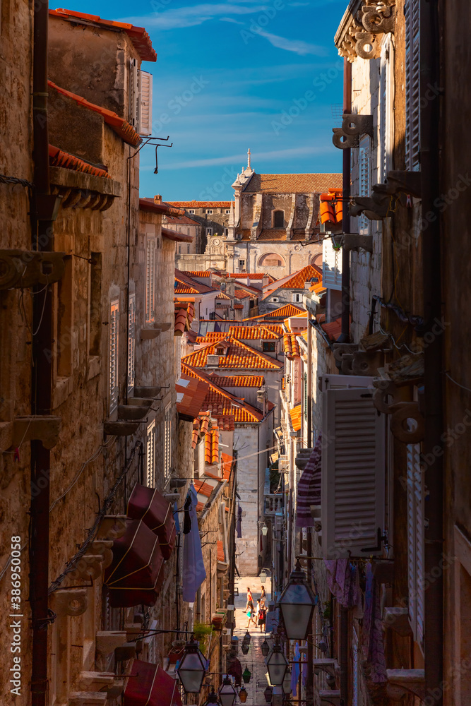 Medieval street with stairs in famous european city of Dubrovnik on a sunny day.