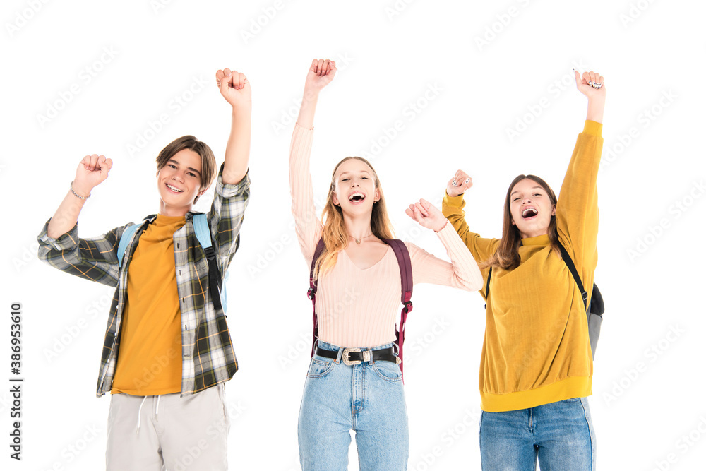 Excited teenagers with backpacks showing yes gesture and looking at camera isolated on white Excited teenagers with backpacks showing yes gesture and looking at camera isolated on white